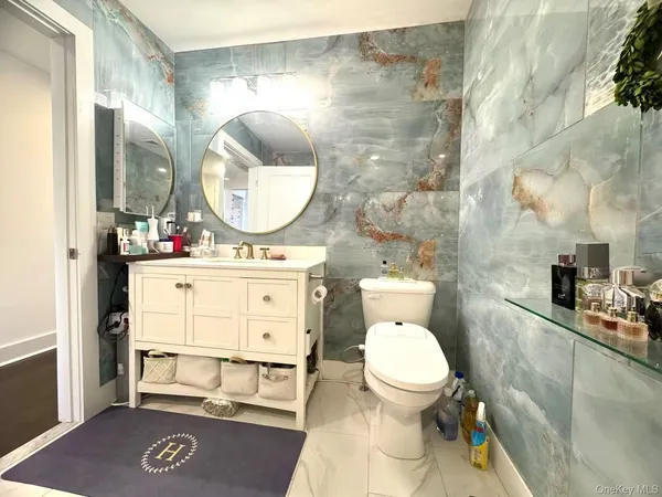 a bathroom with a toilet a sink and a mirror