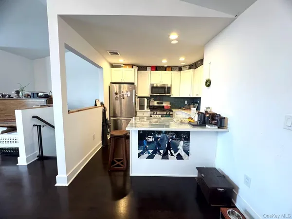 a kitchen with stainless steel appliances a refrigerator and a stove top oven
