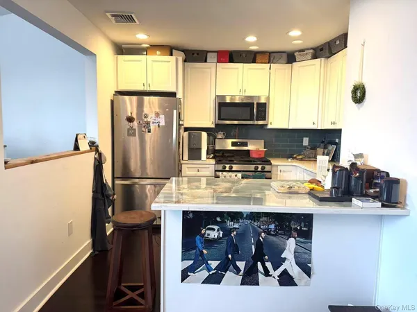 a kitchen with stainless steel appliances a refrigerator and a stove
