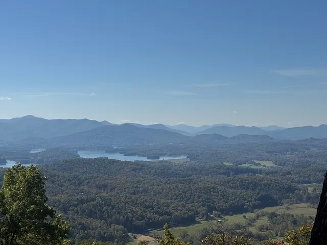 a view of a dry field with mountains in the background