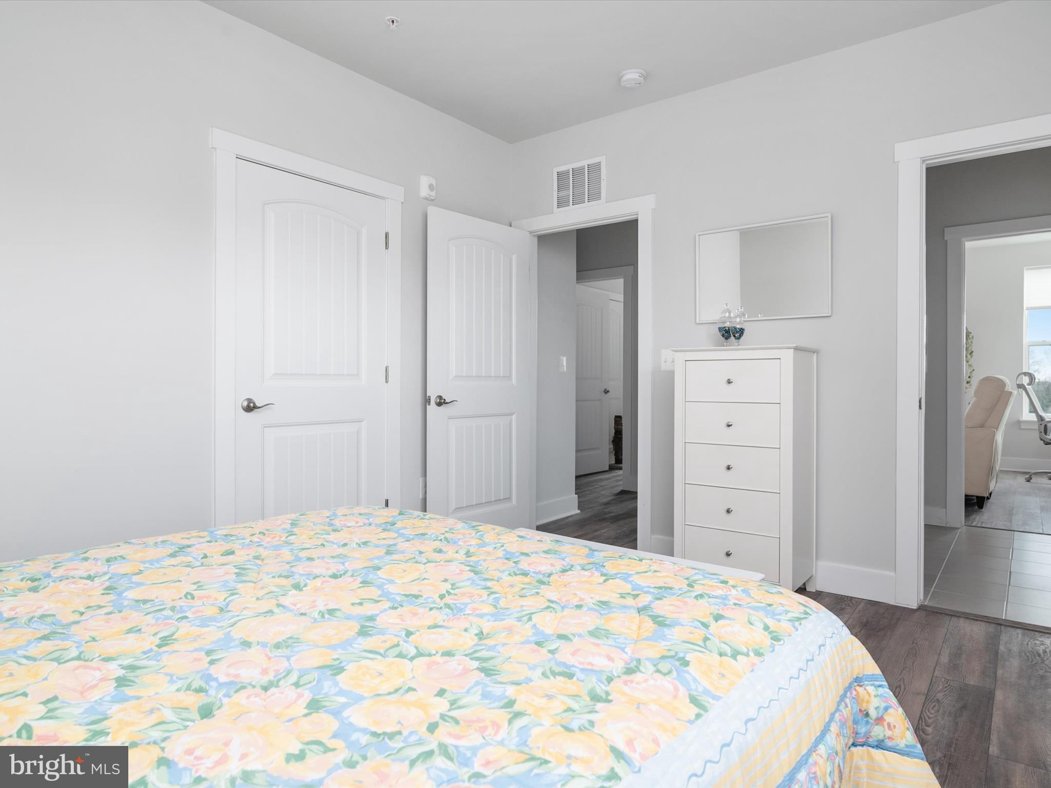 141 Switchgrass Way, Unit 34 Chester, MD 21619 - Photo 27 of 61 a bedroom with a bed and a dresser
