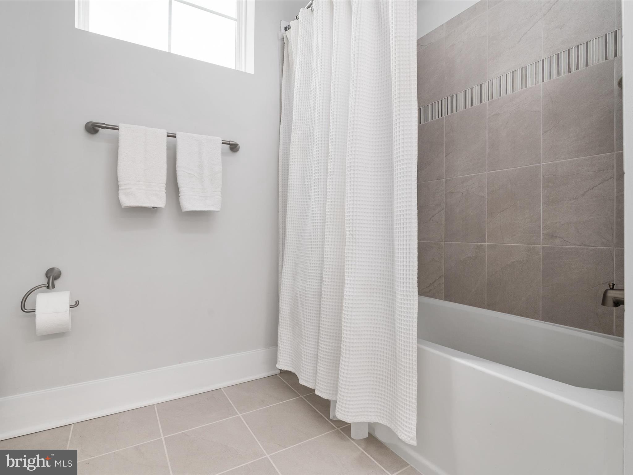 141 Switchgrass Way, Unit 34 Chester, MD 21619 - Photo 29 of 61 a bathroom with a bathtub