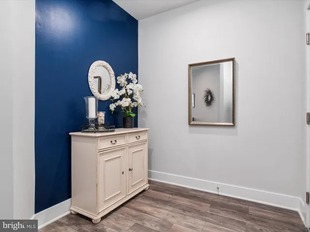 a kitchen with stainless steel appliances a table chairs and white cabinets