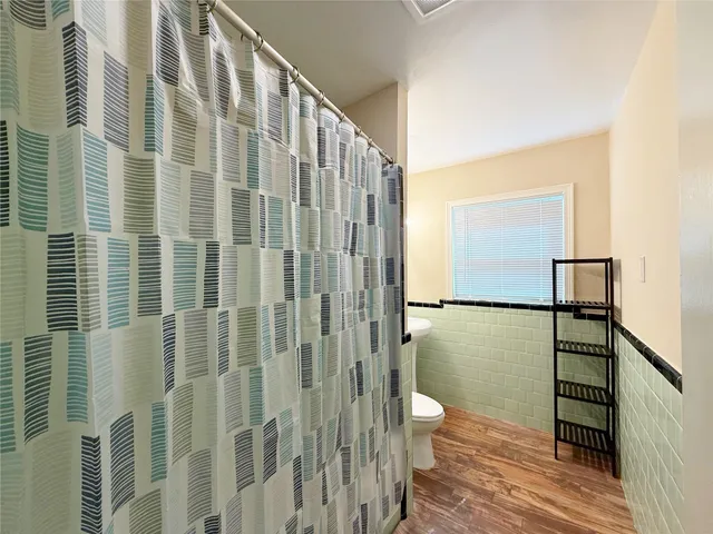 a bathroom with a shower and a toilet