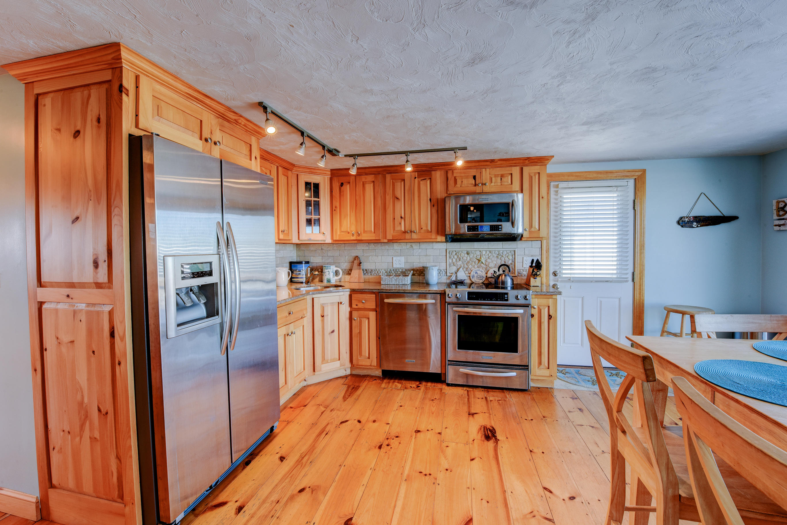 215 Phillips Road Sandwich, MA 02563 - Photo 8 of 26 a kitchen with stainless steel appliances granite countertop a refrigerator a stove top oven a sink and dishwasher