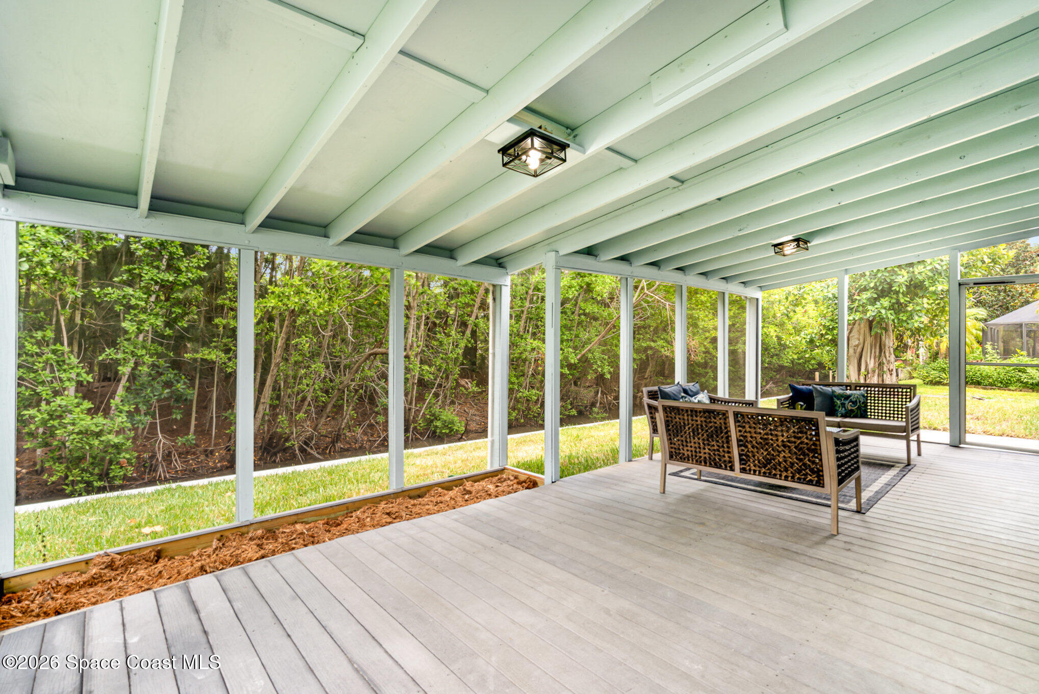 362 Nikomas Way Melbourne Beach, FL 32951 - Photo 23 of 32 a view of a porch with wooden floor and furniture