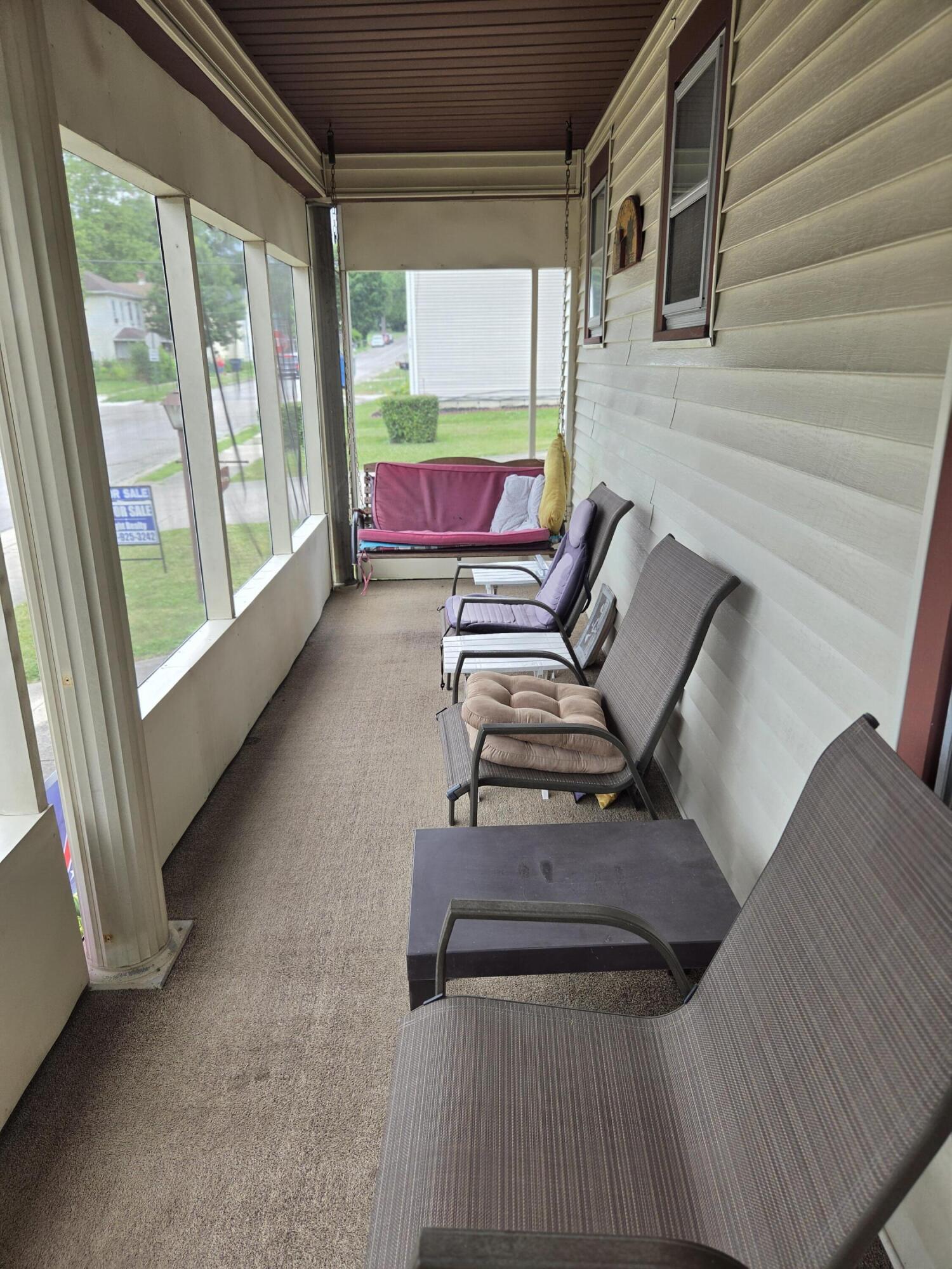 1909 West Washington Street Springfield, OH 45506 - Photo 3 of 28 Enclosed porch with swing