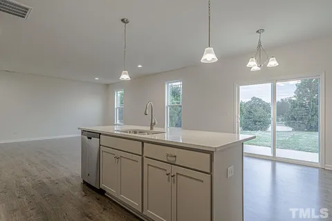 a view of a kitchen island a chandelier and wooden floor