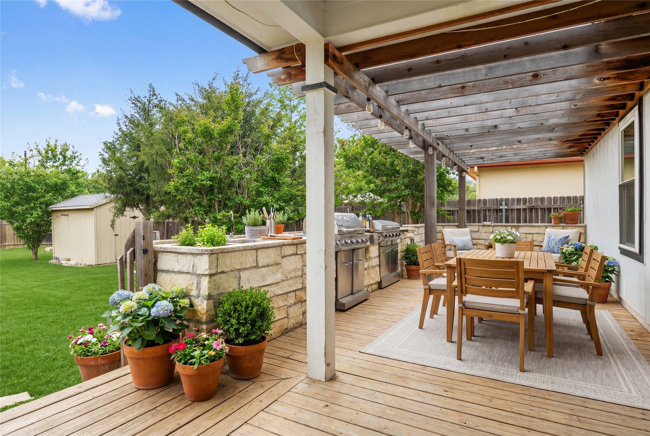 14409 Sandifer Street Austin, TX 78725 - Photo 3 of 31 Virtually Staged. Wooden deck with a fenced backyard, a storage shed, an outdoor kitchen / dining area, and a pergola