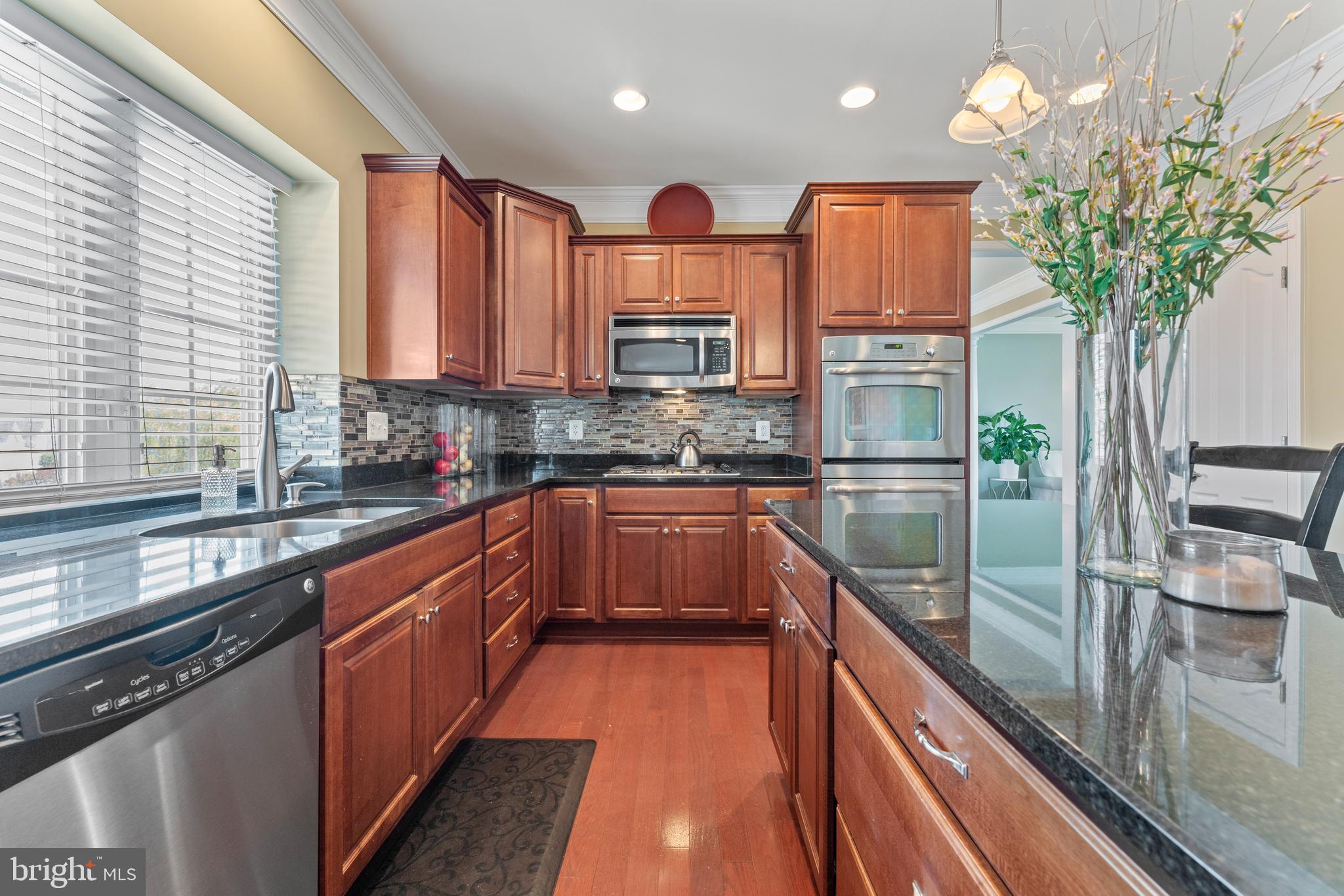 16 Barley Mill Court Stafford, VA 22554 - Photo 11 of 48 a kitchen with stainless steel appliances granite countertop a sink a stove and a wooden floors