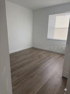 3495 Harborside Avenue Fort Pierce, FL 34946 - Photo 6 of 15 a view of an empty room with wooden floor and a window