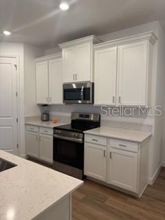 3495 Harborside Avenue Fort Pierce, FL 34946 - Photo 9 of 15 a kitchen with a sink stove top oven and cabinets