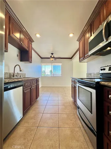 a kitchen with stainless steel appliances granite countertop a stove and a sink
