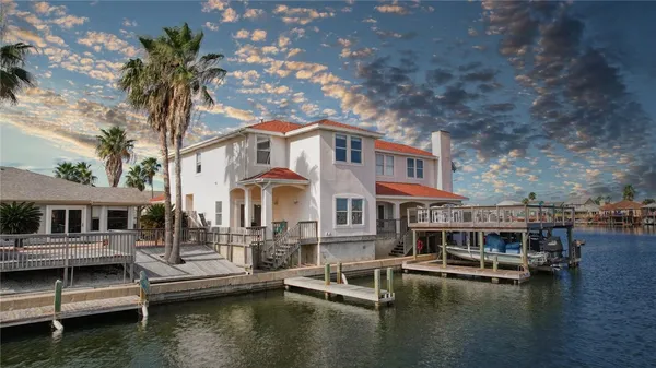 a view of house with swimming pool and sitting area