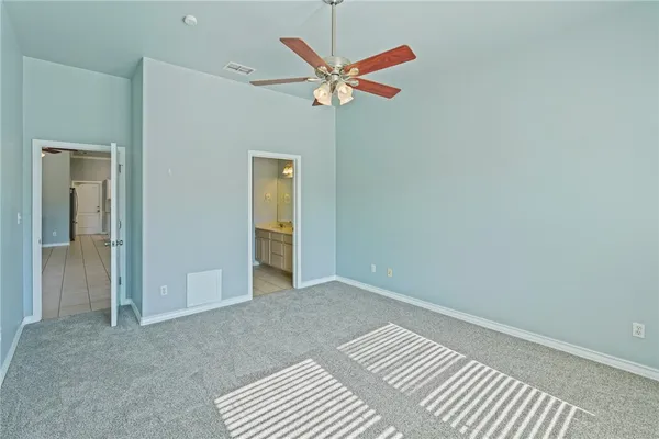 a view of room with a ceiling fan