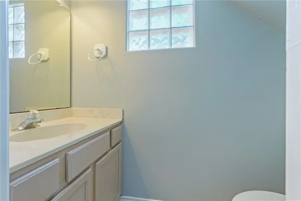a bathroom with a granite countertop sink and a mirror
