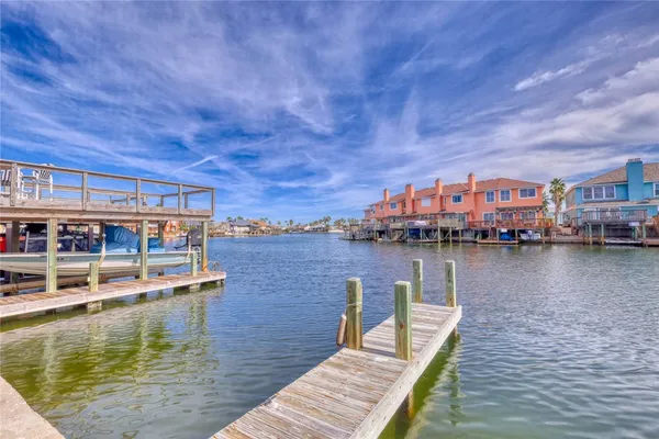 a view of a lake with boats and a bridge