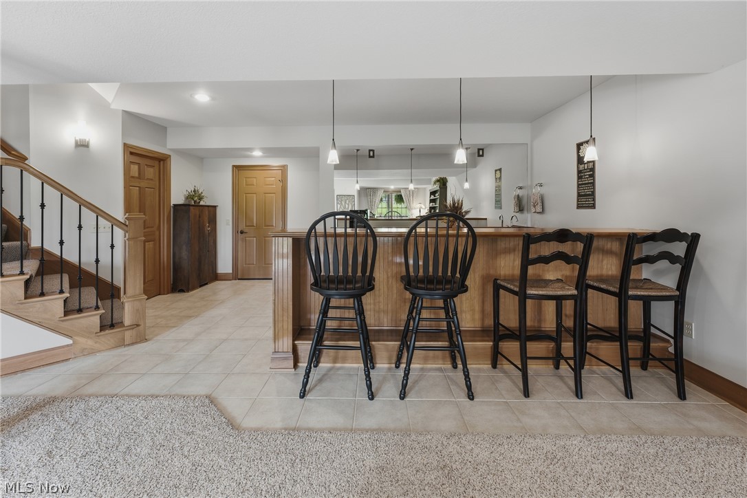3955 Spring Brook Way Wooster, OH 44691 - Photo 29 of 50 Custom bar with wood-finish cabinetry and pendant lighting