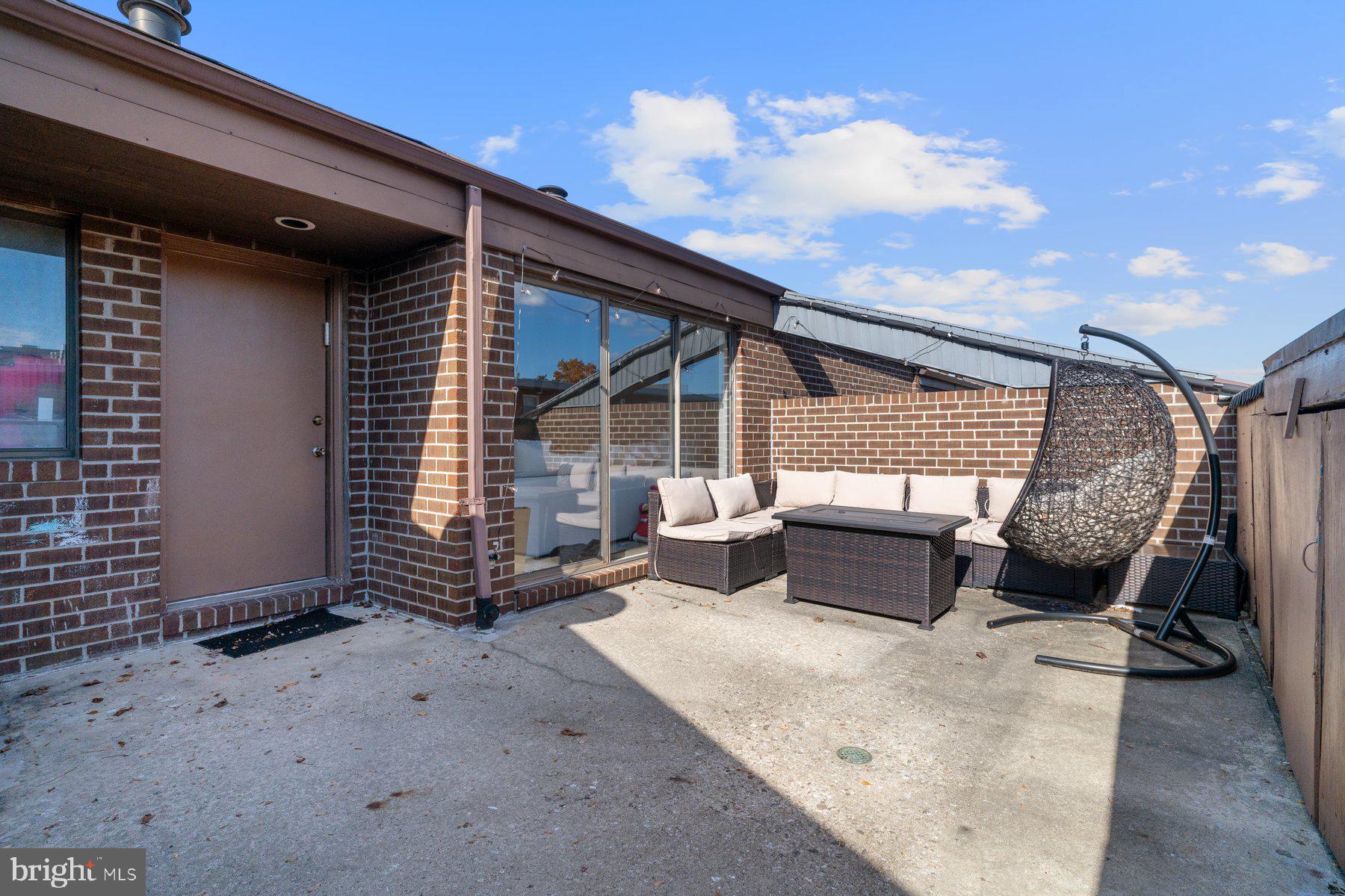 a backyard of a house with barbeque oven table and chairs