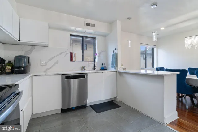 a kitchen with stainless steel appliances granite countertop a sink and cabinets