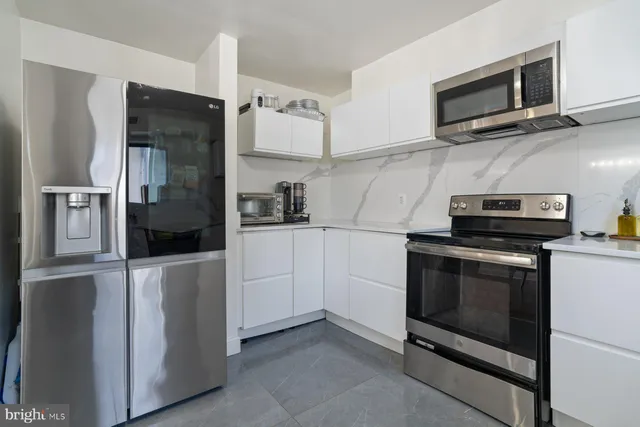 a kitchen with cabinets and steel stainless steel appliances