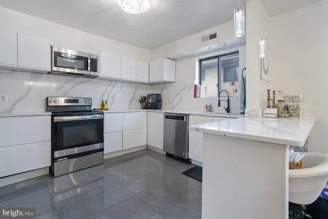 a kitchen with a sink stove and cabinets