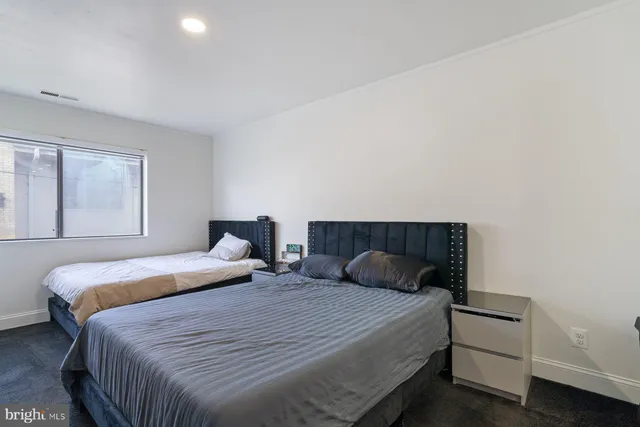 a bedroom with a bed and window