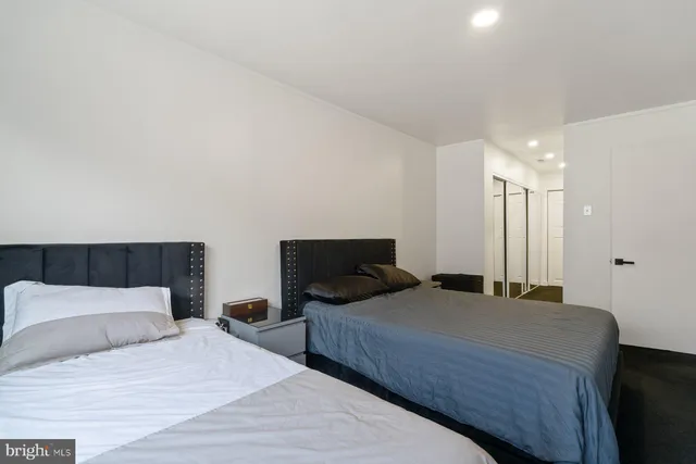 a bedroom with a large bed and wooden floor