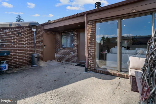 a view of a porch with a table and chairs