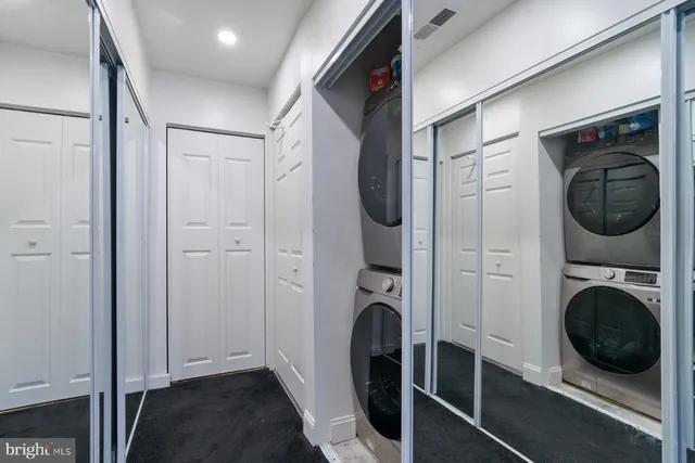 a view of a storage and utility room with a washer dryer