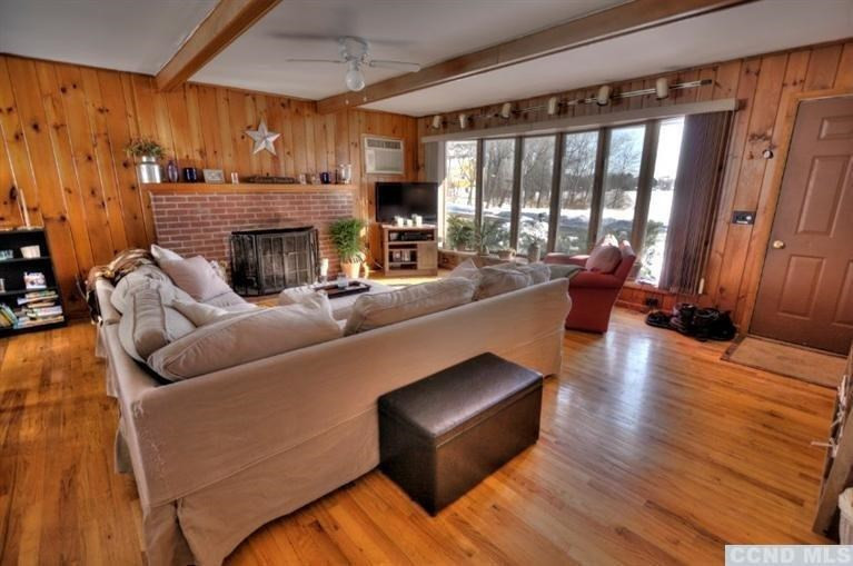 1047 Lakeview Road Copake, NY 12516 - Photo 6 of 10 a living room with furniture and a fireplace