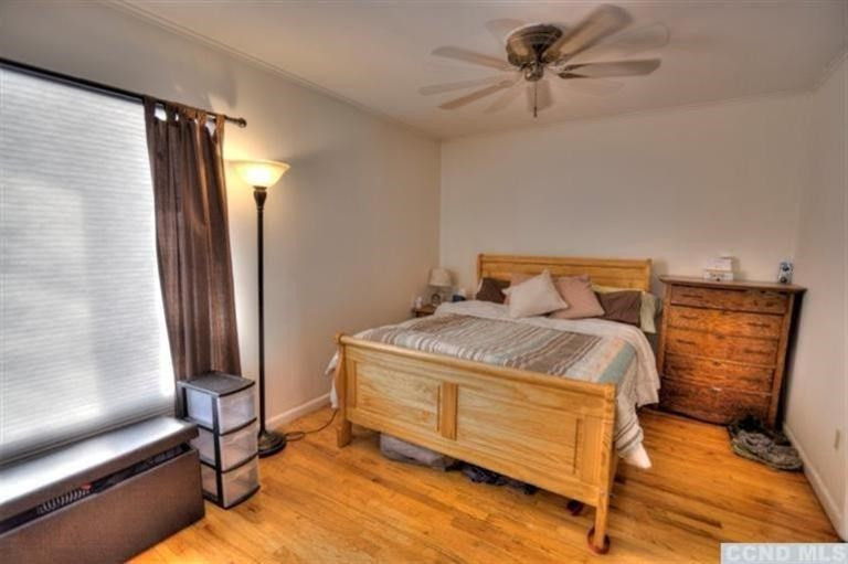 1047 Lakeview Road Copake, NY 12516 - Photo 9 of 10 a bedroom with a bed and a chandelier