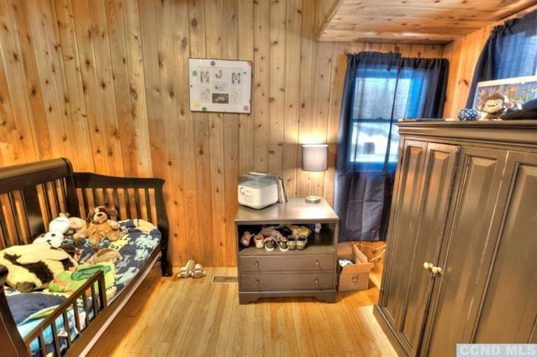 1047 Lakeview Road Copake, NY 12516 - Photo 10 of 10 a bedroom with bed and wooden floor