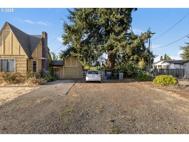 a view of house with backyard and deck