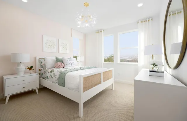 a bedroom with a bed a mirror and a large window