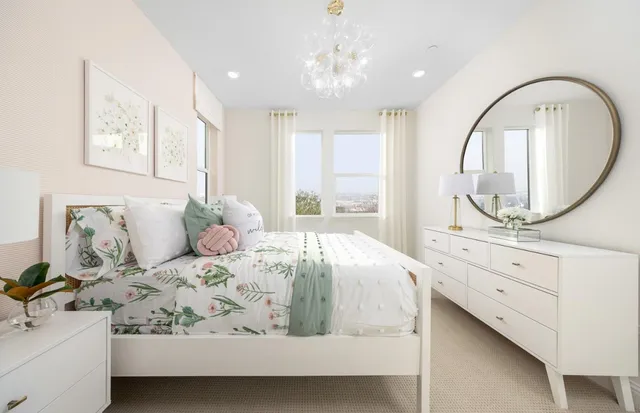 a bedroom with bed a mirror and a window