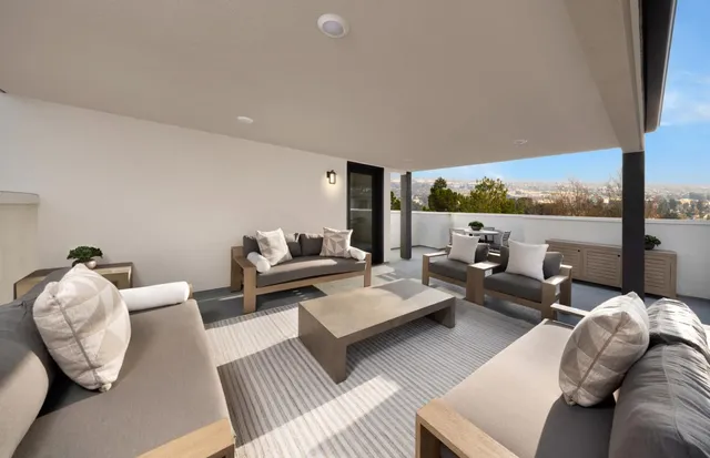 a living room with furniture and a floor to ceiling window