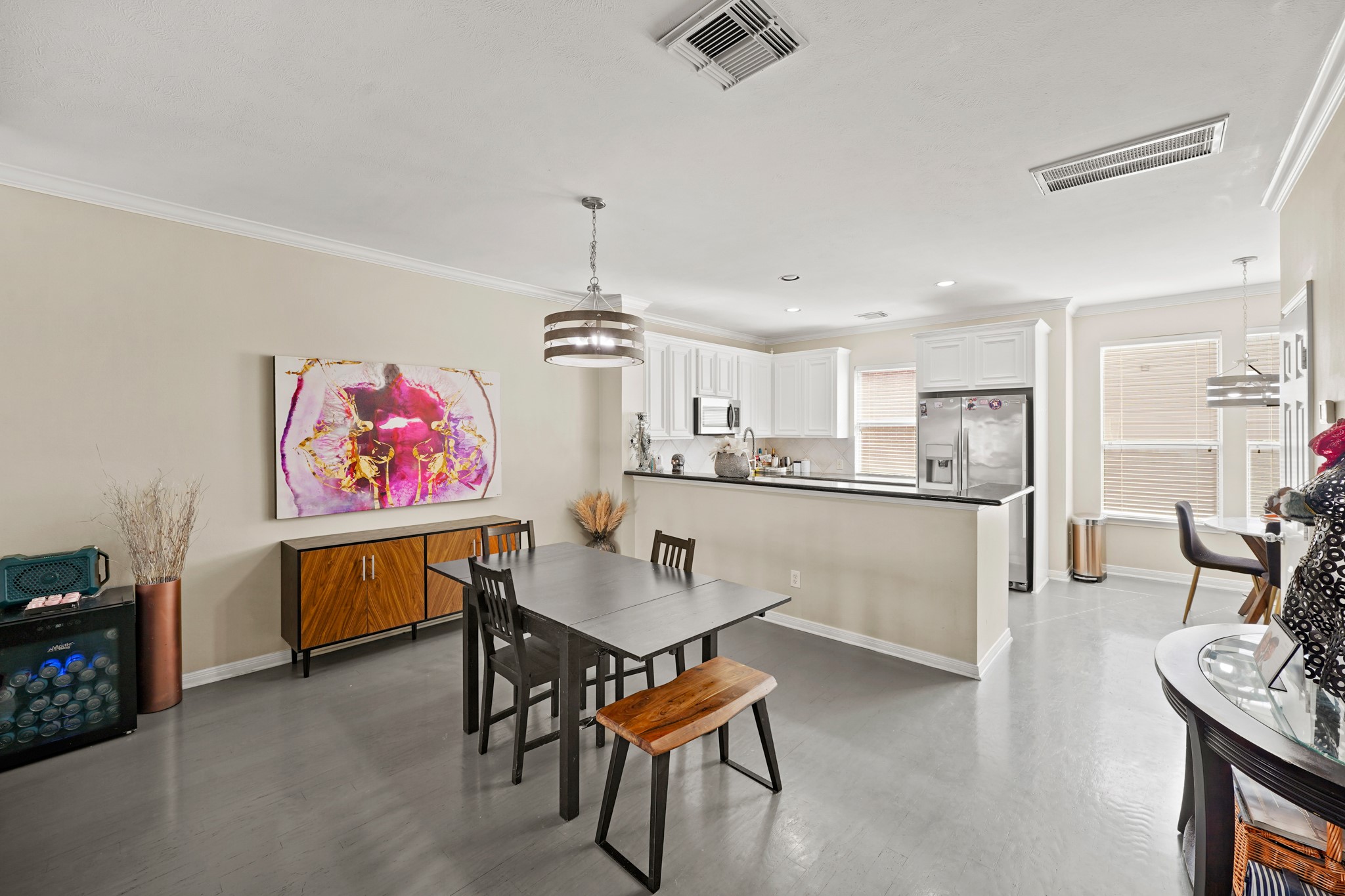 2605 West Dallas Street Houston, TX 77019 - Photo 11 of 29 a open kitchen with stainless steel appliances kitchen island granite countertop a dining table chairs and a refrigerator