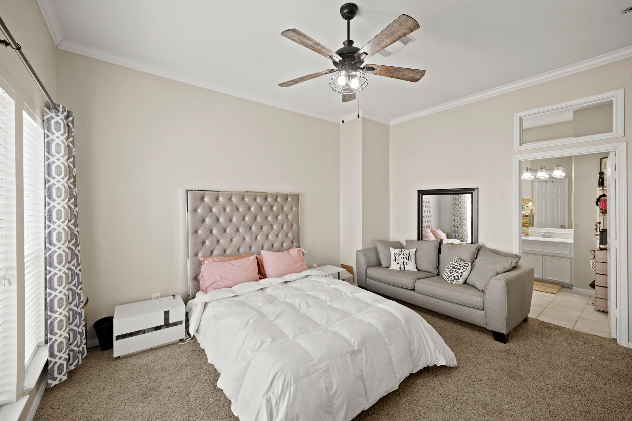 2605 West Dallas Street Houston, TX 77019 - Photo 24 of 29 a spacious bedroom with a bed and a chandelier