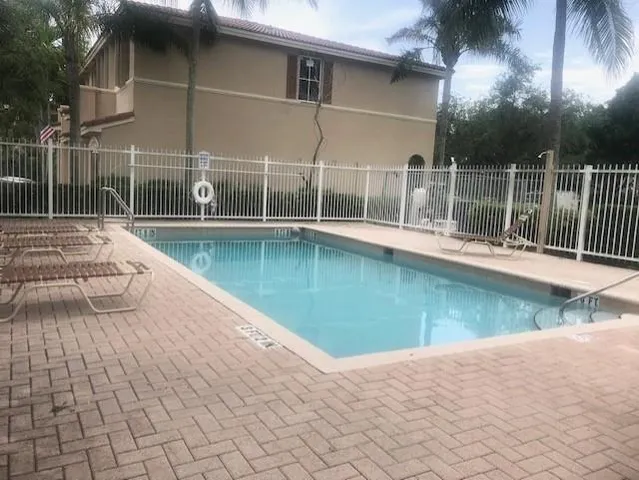 a view of a swimming pool with a yard