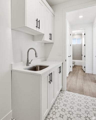 4978 North 75 East Enoch, UT 84721 - Photo 32 of 60 Bar area featuring white cabinetry and light stone countertops
