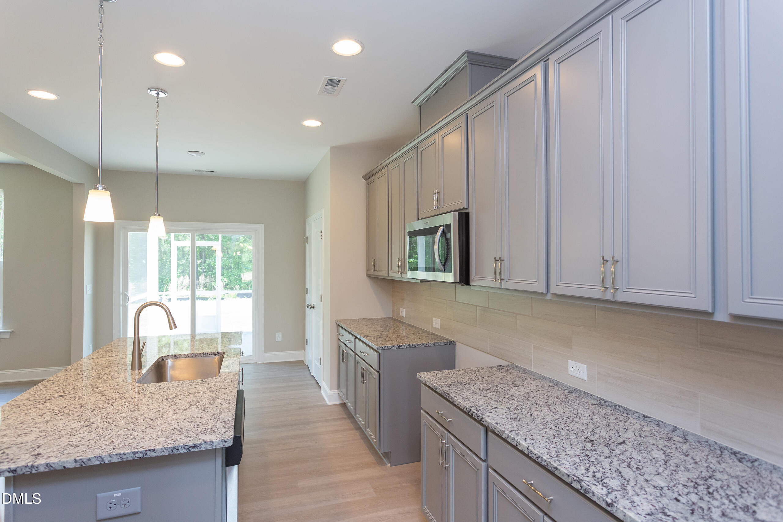4921 Theater Way, Unit 7 Raleigh, NC 27604 - Photo 6 of 37 a kitchen with stainless steel appliances granite countertop wooden cabinets a oven and granite counter tops