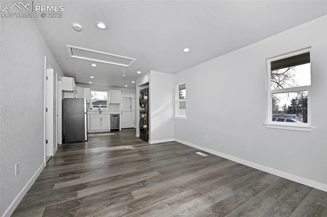 a view of kitchen with refrigerator microwave and wooden floor
