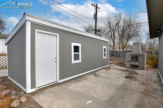 a view of a house with a backyard and garage