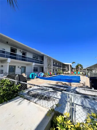 a wooden bench sitting in front of a building