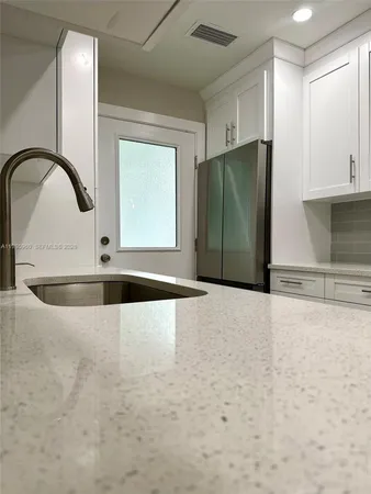 a view of a kitchen with a sink and cabinets