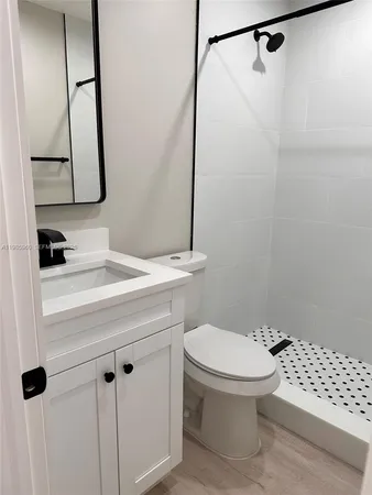 a bathroom with a sink a toilet and a mirror