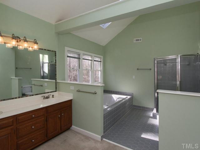 12400 Whartons Way Raleigh, NC 27613 - Photo 10 of 23 Spacious master bath with large whirlpool tub, separate shower,large window and skylight, dual sink and spacious vanity. Master Bath/Spa