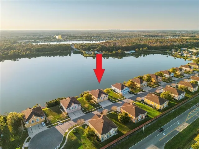 an aerial view of a house with outdoor seating