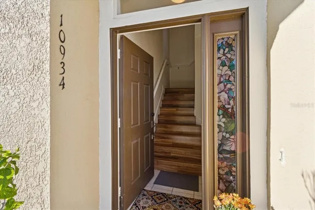 a view of a hallway with wooden floor and entryway